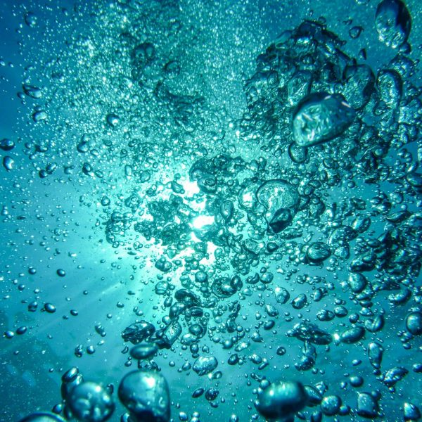 air-bubbles-diving-underwater-blow-62307-62307 Capture of underwater bubbles rising towards the surface with sunlight streaming through.